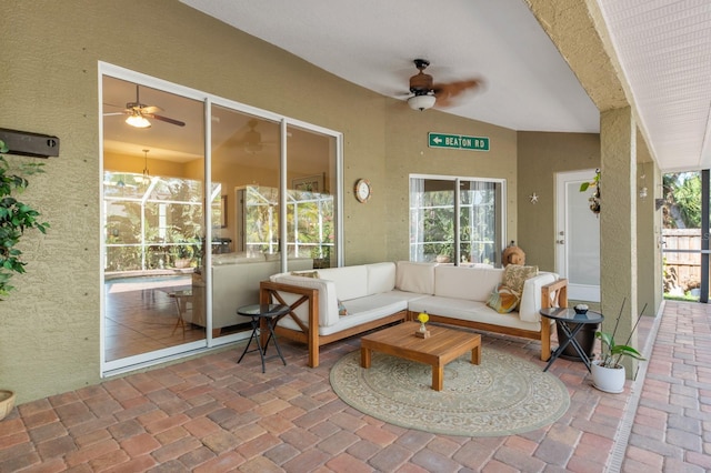 sunroom / solarium with ceiling fan and lofted ceiling