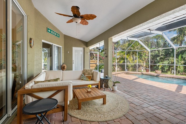 sunroom with ceiling fan, outdoor lounge area, and a patio area