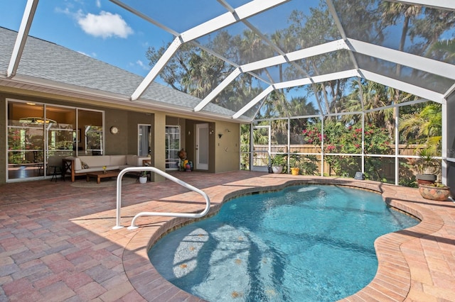 view of swimming pool with outdoor lounge area, a lanai, and a patio area