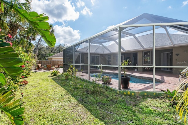 view of pool featuring a lanai, a lawn, and a patio