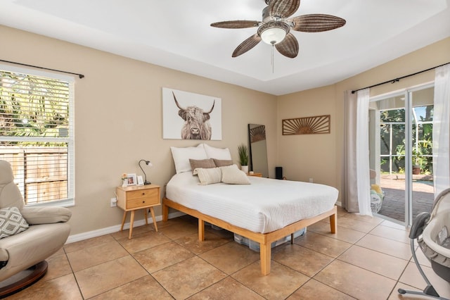 bedroom with access to exterior, light tile patterned floors, and ceiling fan