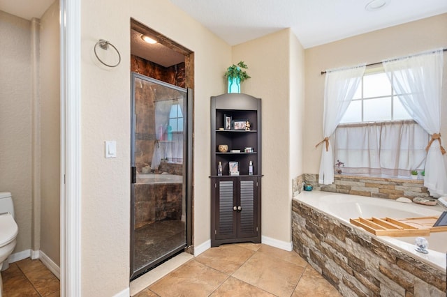 bathroom featuring shower with separate bathtub, tile patterned floors, and toilet