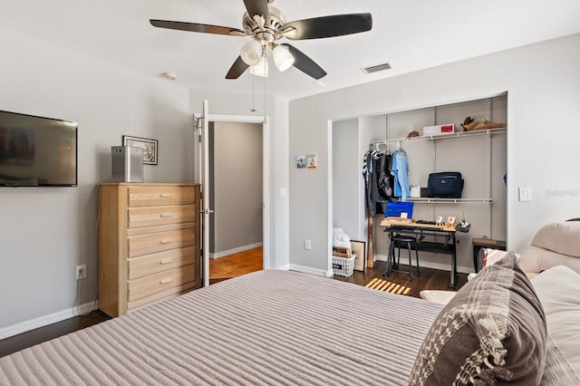 bedroom featuring dark wood-type flooring, ceiling fan, and a closet