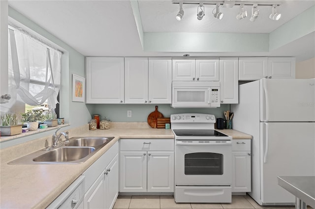 kitchen featuring white cabinetry, white appliances, sink, and light tile patterned floors