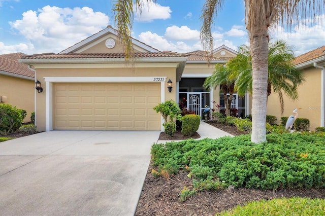 mediterranean / spanish-style house with a garage