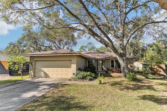 single story home with a garage and a front lawn