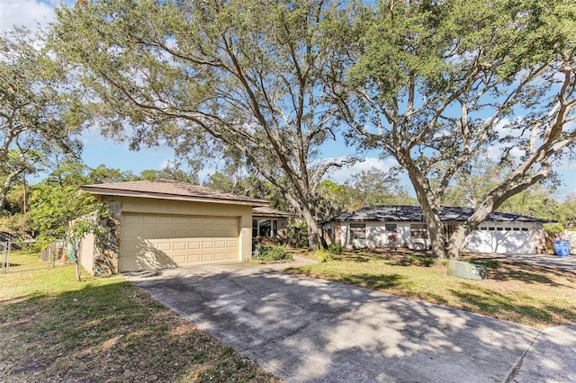 view of front of home with a garage and a front lawn