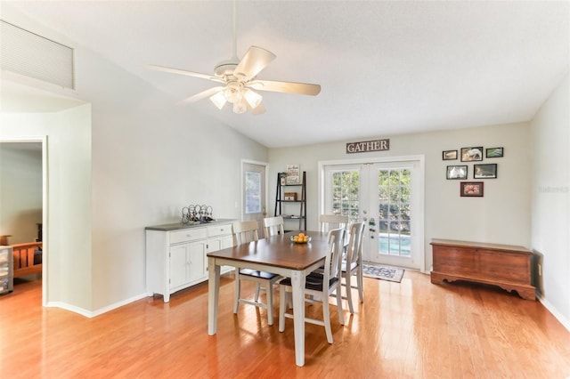 dining area featuring vaulted ceiling, ceiling fan, light wood-type flooring, and french doors