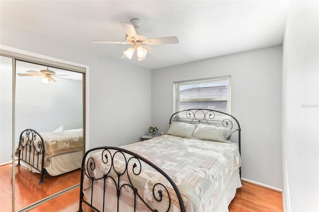 bedroom featuring light hardwood / wood-style flooring, a closet, and ceiling fan