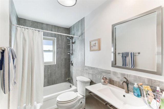 full bathroom featuring vanity, tile walls, shower / tub combo, and toilet