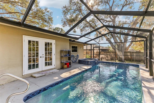 view of swimming pool with an outdoor fire pit, a patio area, glass enclosure, and french doors