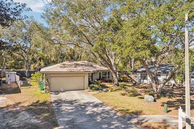 view of front of property featuring a garage and a front lawn