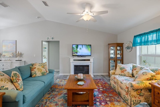 living room featuring ceiling fan, lofted ceiling, and a premium fireplace