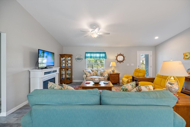 living room featuring ceiling fan and vaulted ceiling