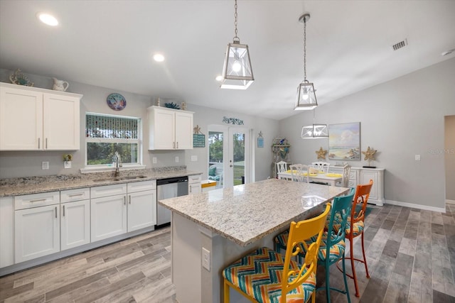 kitchen with a kitchen island, white cabinetry, sink, hanging light fixtures, and stainless steel dishwasher