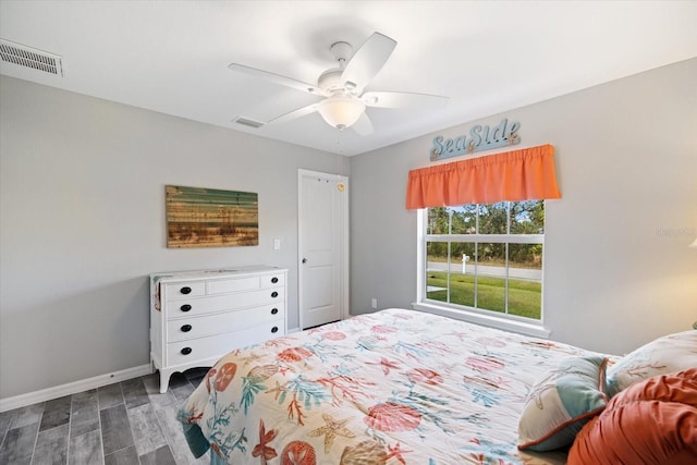 bedroom with dark wood-type flooring and ceiling fan