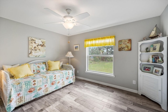 bedroom featuring hardwood / wood-style flooring and ceiling fan