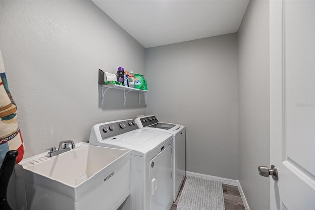 washroom featuring washing machine and dryer and sink