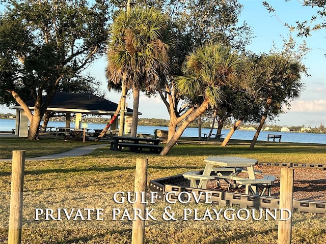 view of community with a yard, a gazebo, and a water view