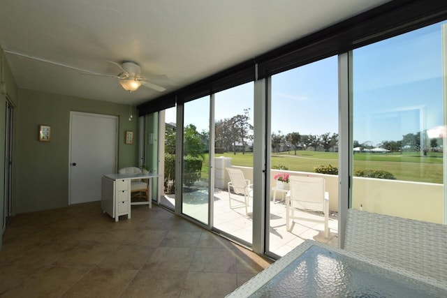 entryway with ceiling fan and floor to ceiling windows