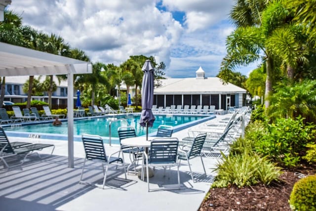 view of pool with a pergola and a patio