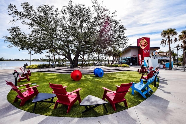 view of community with a water view and a lawn