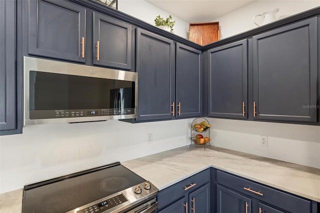 kitchen with blue cabinetry and stainless steel appliances