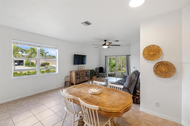 tiled dining area featuring ceiling fan