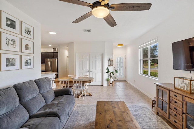 living room with light tile patterned flooring and ceiling fan