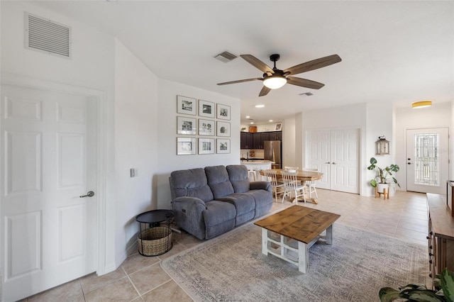 tiled living room with ceiling fan