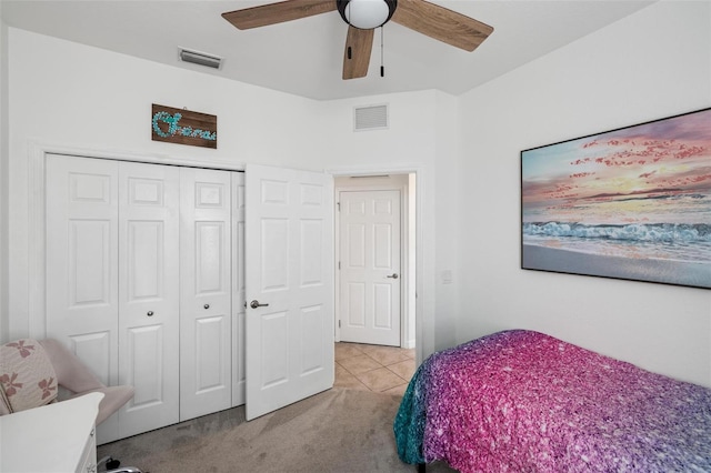 carpeted bedroom featuring ceiling fan and a closet