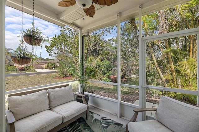 sunroom featuring ceiling fan and a wealth of natural light