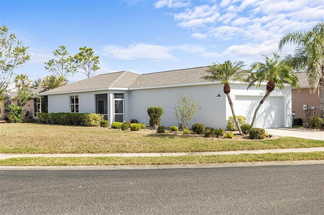 view of front of property with a garage and a front lawn