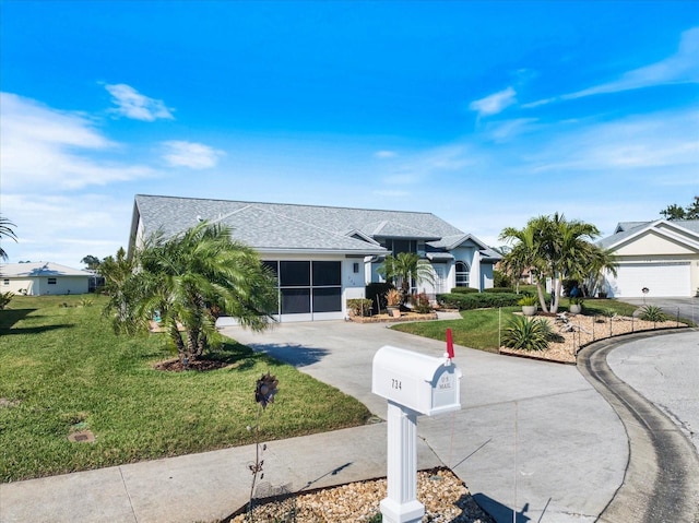 ranch-style home with a garage and a front lawn