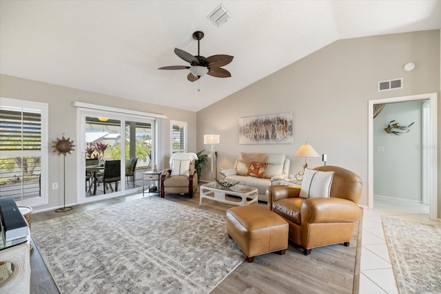 tiled living room featuring vaulted ceiling and ceiling fan