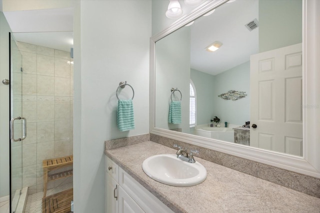 bathroom featuring vanity and separate shower and tub