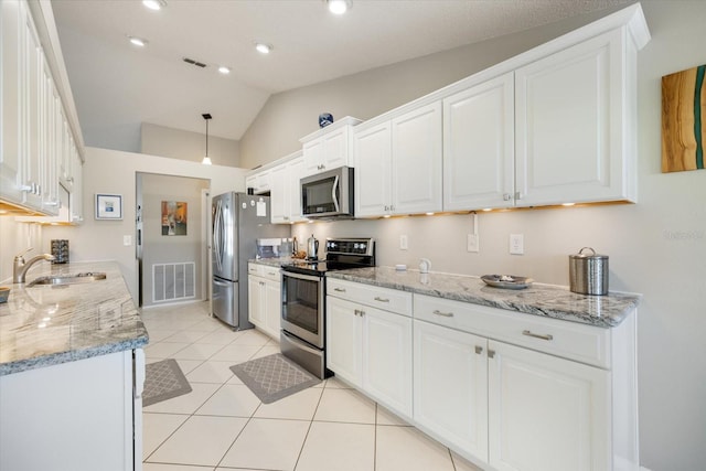 kitchen with white cabinetry, stainless steel appliances, sink, and light stone counters