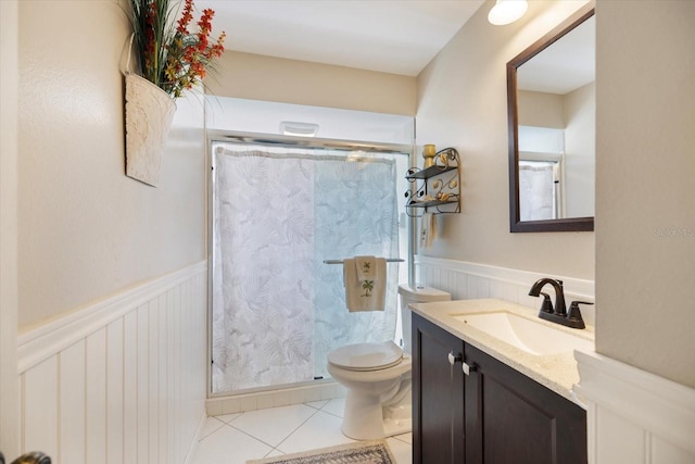 bathroom with a shower with curtain, tile patterned floors, vanity, and toilet