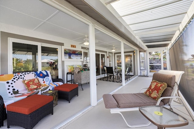 sunroom / solarium featuring ceiling fan