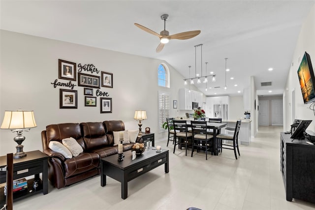 living room featuring high vaulted ceiling and ceiling fan