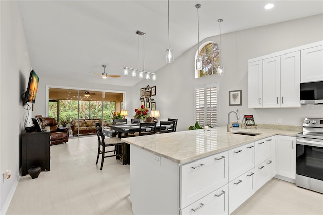 kitchen with pendant lighting, sink, stainless steel appliances, and kitchen peninsula