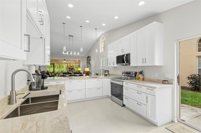 kitchen featuring sink, stainless steel appliances, light stone countertops, decorative light fixtures, and kitchen peninsula