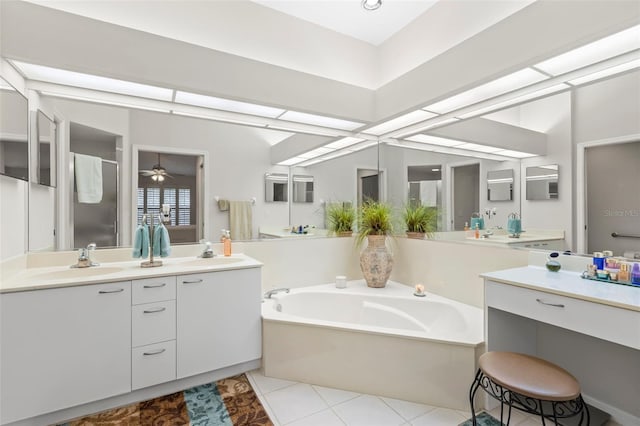 bathroom with ceiling fan, vanity, a bathing tub, and tile patterned flooring