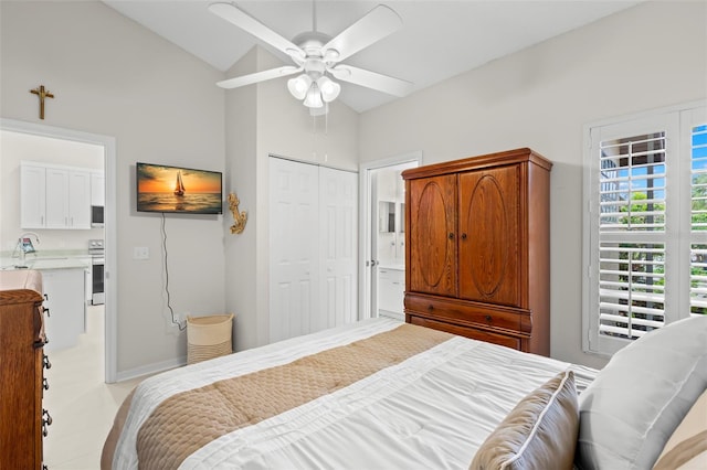 bedroom with vaulted ceiling, ceiling fan, and a closet