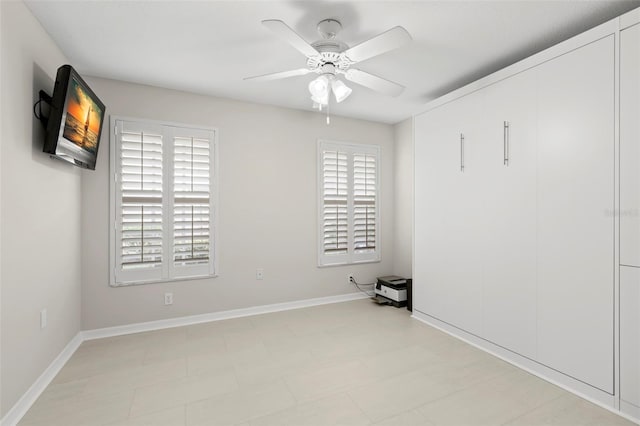 unfurnished room with ceiling fan