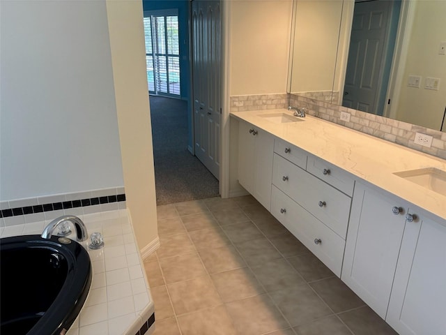 1093 Laurel Woods Dr, Nokomis, FL 34275 - bathroom featuring double vanity, a garden tub, tile patterned flooring, and tasteful backsplash