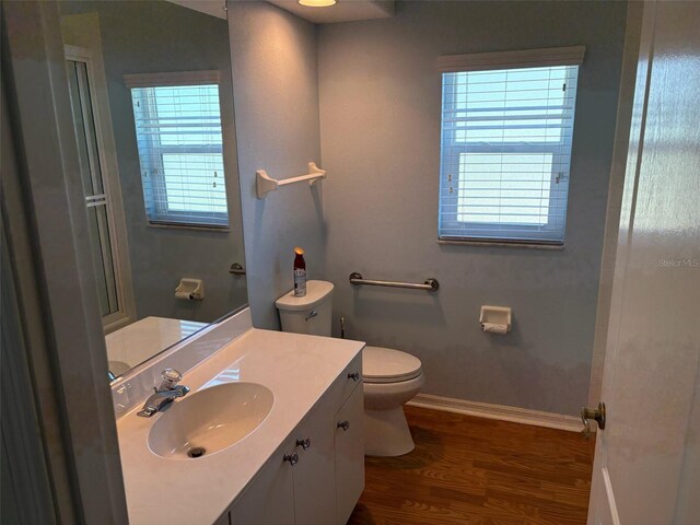 1093 Laurel Woods Dr, Nokomis, FL 34275 - full bath with toilet, baseboards, wood finished floors, and vanity