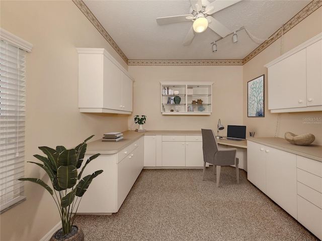 1093 Laurel Woods Dr, Nokomis, FL 34275 - office space featuring built in desk, ceiling fan, track lighting, and a textured ceiling