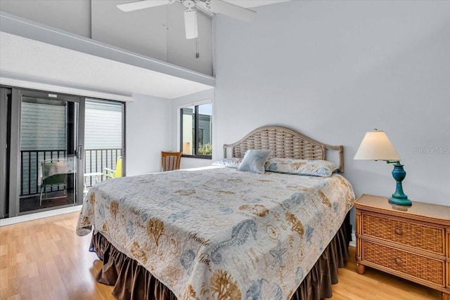 bedroom with a towering ceiling, access to exterior, ceiling fan, and light hardwood / wood-style flooring