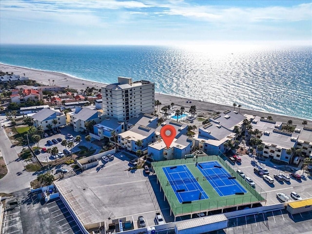 drone / aerial view with a beach view and a water view